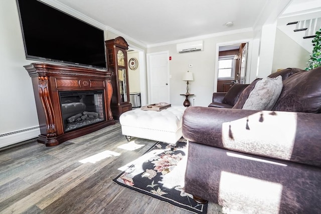 living room featuring a glass covered fireplace, wood finished floors, ornamental molding, and an AC wall unit