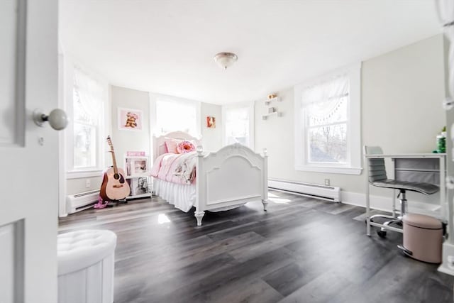 bedroom featuring a baseboard heating unit, baseboards, and dark wood-type flooring