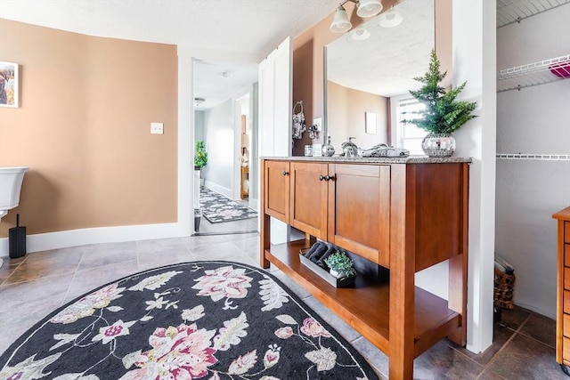 interior space with tile patterned floors and baseboards