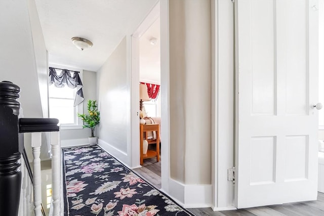 hall with wood finished floors and baseboards