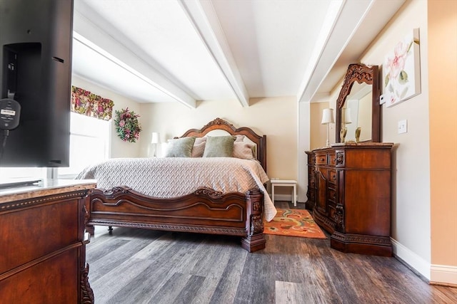 bedroom with beam ceiling, wood finished floors, and baseboards