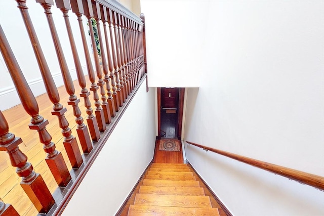 stairway with hardwood / wood-style floors