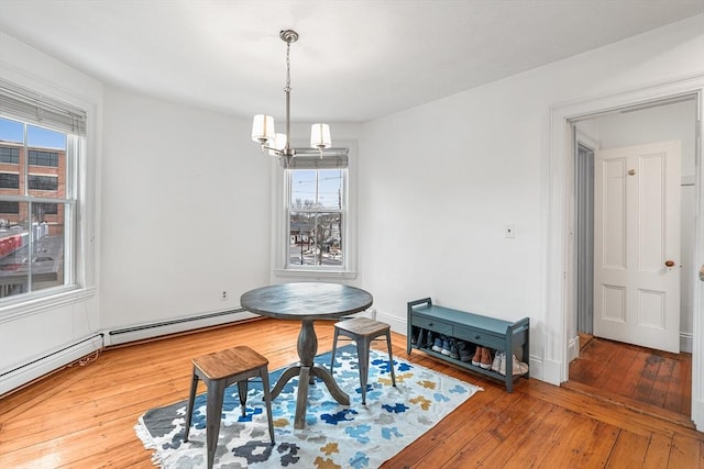 dining room featuring wood-type flooring and an inviting chandelier