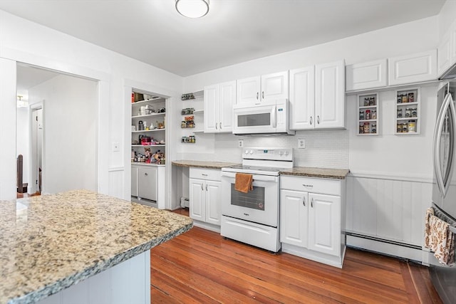 kitchen with white cabinetry, a baseboard radiator, light stone countertops, and white appliances