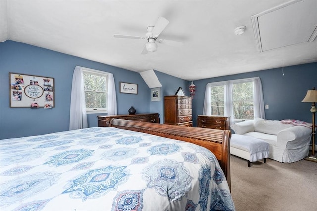 bedroom featuring lofted ceiling, a ceiling fan, carpet, and attic access