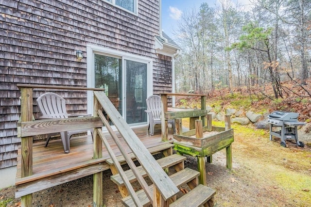 wooden terrace with a grill
