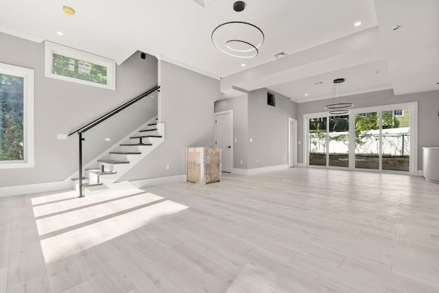 unfurnished living room with light hardwood / wood-style flooring and ornamental molding