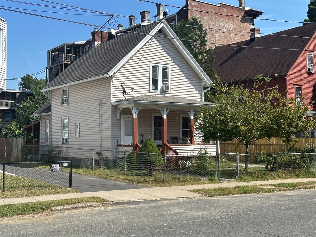 view of front of house with cooling unit and covered porch