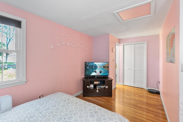 206 Cordaville Rd, Southborough, MA 01772 - bedroom with wood finished floors, multiple windows, a closet, and baseboards