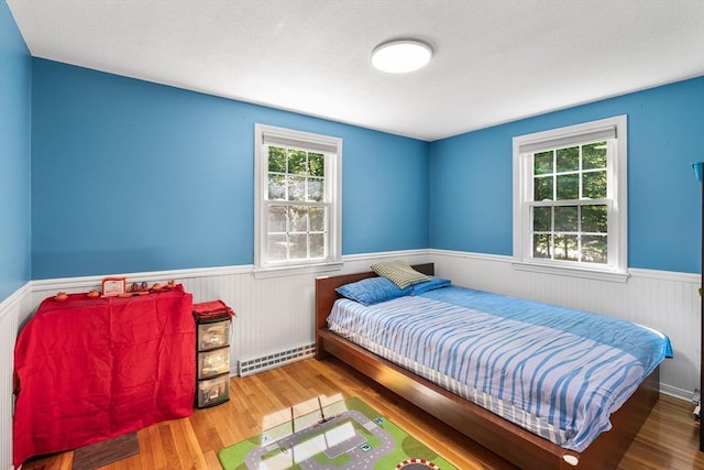 206 Cordaville Rd, Southborough, MA 01772 - bedroom with a wainscoted wall, multiple windows, and wood finished floors
