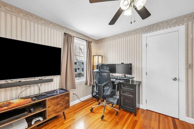 home office with wood-type flooring and ceiling fan