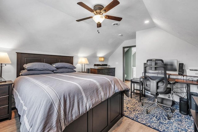 bedroom featuring ceiling fan, vaulted ceiling, and light wood-type flooring