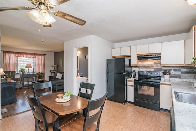 kitchen featuring ceiling fan, light countertops, decorative backsplash, under cabinet range hood, and black appliances