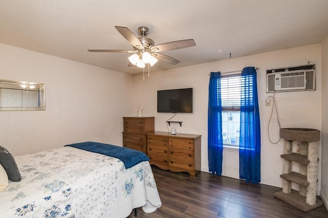 bedroom featuring baseboards, ceiling fan, an AC wall unit, and wood finished floors