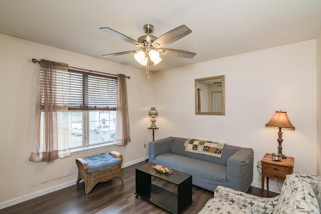 living area with baseboards, a ceiling fan, and wood finished floors