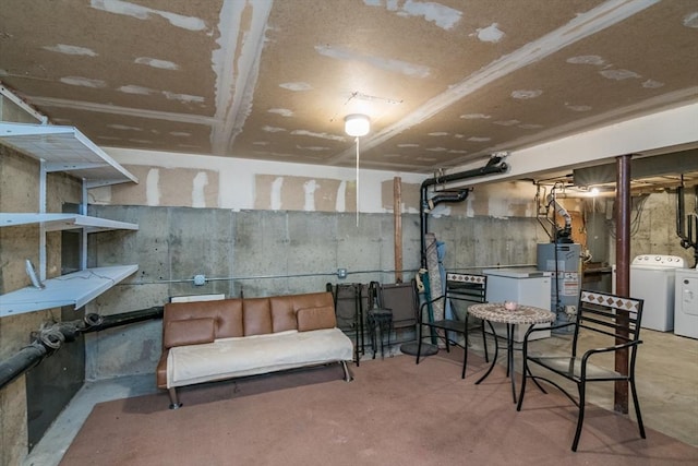 unfinished basement featuring gas water heater and washing machine and dryer