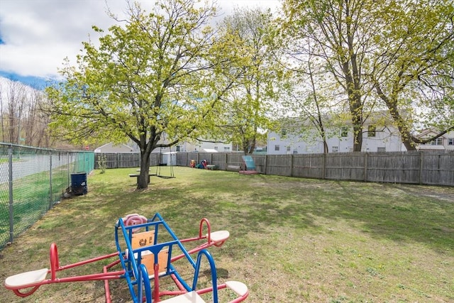 view of yard featuring fence and central air condition unit