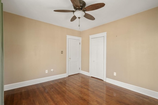 unfurnished room with dark wood-type flooring and ceiling fan