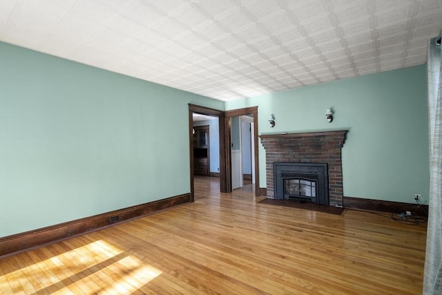 unfurnished living room featuring hardwood / wood-style floors and a fireplace