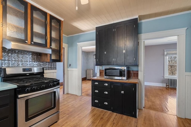 kitchen with light hardwood / wood-style flooring, wooden ceiling, ornamental molding, appliances with stainless steel finishes, and radiator heating unit