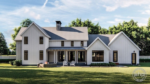 rear view of house featuring a porch and a yard