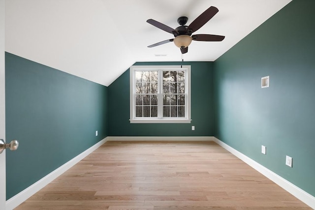 bonus room with light wood-type flooring, vaulted ceiling, baseboards, and ceiling fan