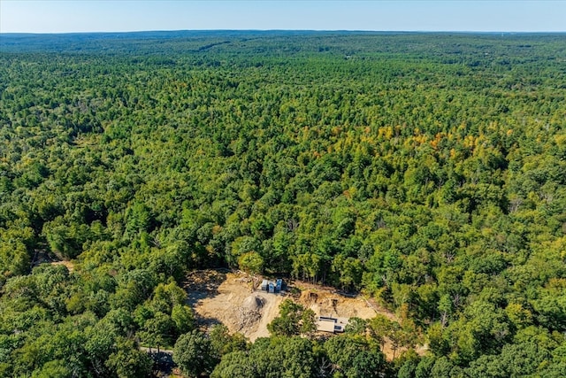 drone / aerial view featuring a forest view