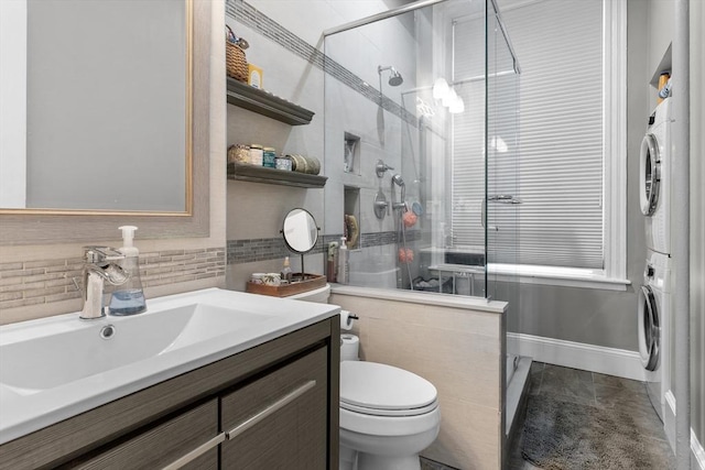 1411 Washington St Unit 4, Boston, MA 02118 - full bath with stacked washing machine and dryer, vanity, a stall shower, and decorative backsplash