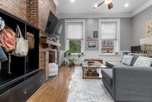 1411 Washington St Unit 4, Boston, MA 02118 - living area with a fireplace, ceiling fan, hardwood / wood-style flooring, ornamental molding, and wainscoting