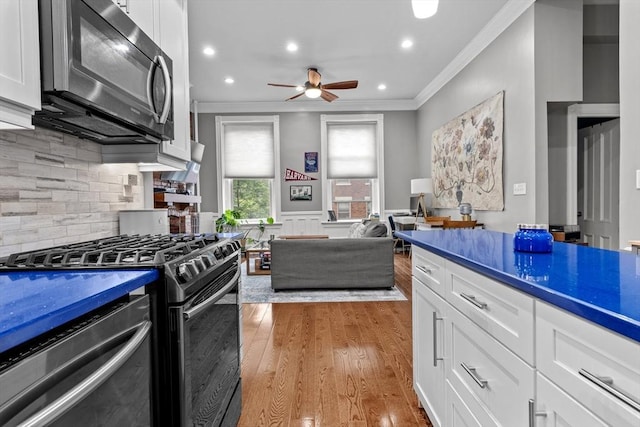 1411 Washington St Unit 4, Boston, MA 02118 - kitchen featuring appliances with stainless steel finishes, ornamental molding, a ceiling fan, recessed lighting, and white cabinetry