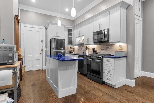1411 Washington St Unit 4, Boston, MA 02118 - kitchen featuring appliances with stainless steel finishes, dark countertops, white cabinets, tasteful backsplash, and recessed lighting