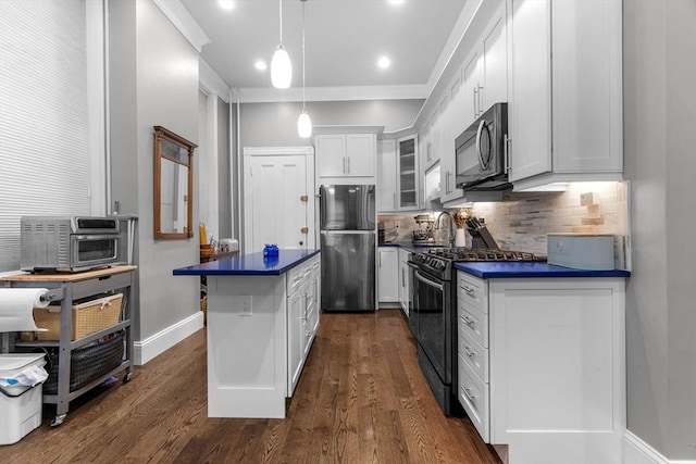 1411 Washington St Unit 4, Boston, MA 02118 - kitchen featuring black appliances, dark countertops, glass insert cabinets, decorative backsplash, and ornamental molding