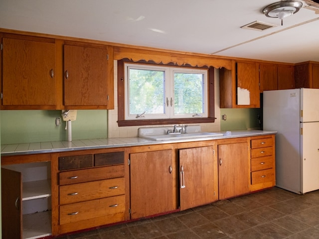 kitchen with sink and white refrigerator