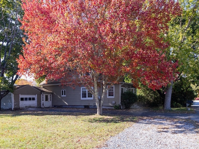 view of front of property with a garage and a front lawn