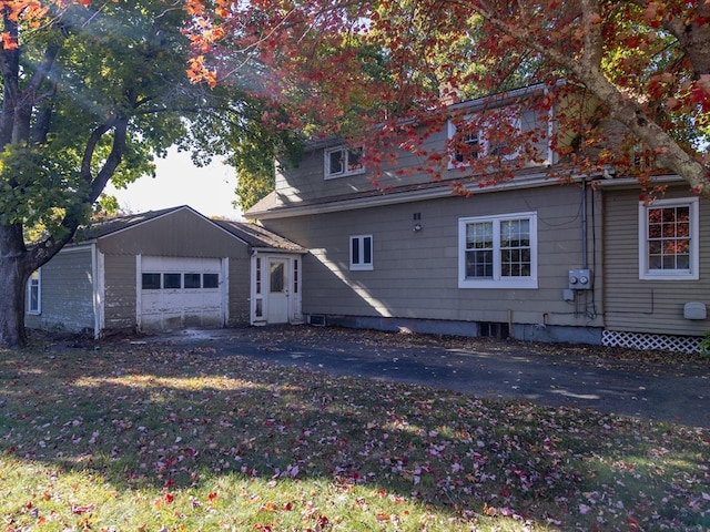 rear view of house featuring a garage