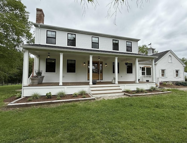 6 Hitching Post Ln, Wilbraham, MA 01095 - view of front of property featuring a chimney, covered porch, and a front yard