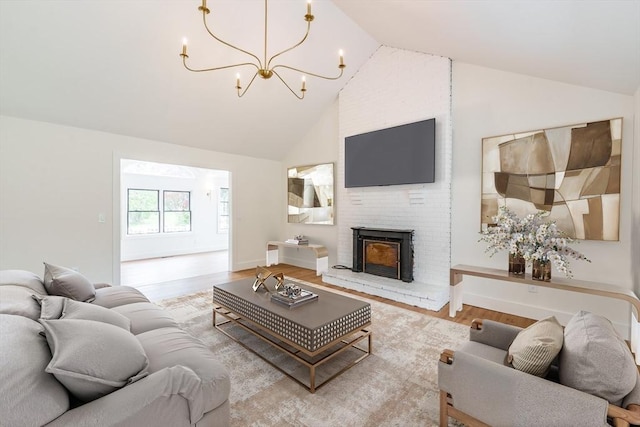 6 Hitching Post Ln, Wilbraham, MA 01095 - living room with wood finished floors, a chandelier, high vaulted ceiling, a brick fireplace, and baseboards