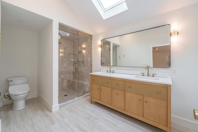 6 Hitching Post Ln, Wilbraham, MA 01095 - bathroom featuring a skylight, baseboards, double vanity, a shower stall, and toilet