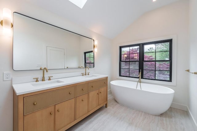6 Hitching Post Ln, Wilbraham, MA 01095 - bathroom with double vanity, plenty of natural light, lofted ceiling, a soaking tub, and baseboards