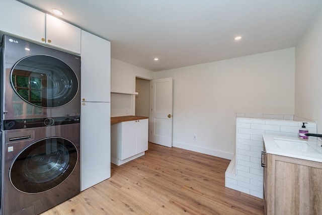 6 Hitching Post Ln, Wilbraham, MA 01095 - laundry area featuring estacked washer and dryer, light wood finished floors, baseboards, and recessed lighting