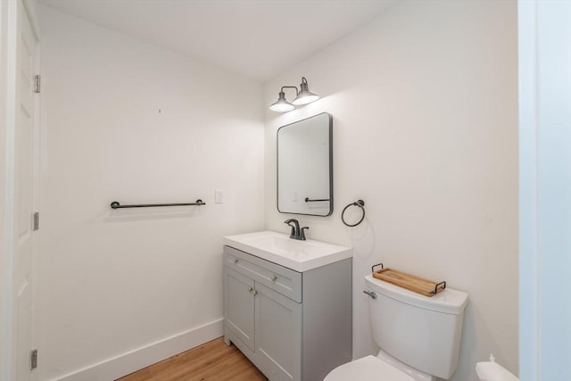 6 Hitching Post Ln, Wilbraham, MA 01095 - bathroom with toilet, vanity, wood finished floors, and baseboards