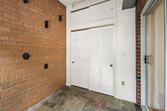 12 Commonwealth Ct Unit 12-16, Boston, MA 02135 - bathroom with brick wall and stone tile floors