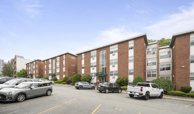 12 Commonwealth Ct Unit 12-16, Boston, MA 02135 - view of building exterior featuring uncovered parking