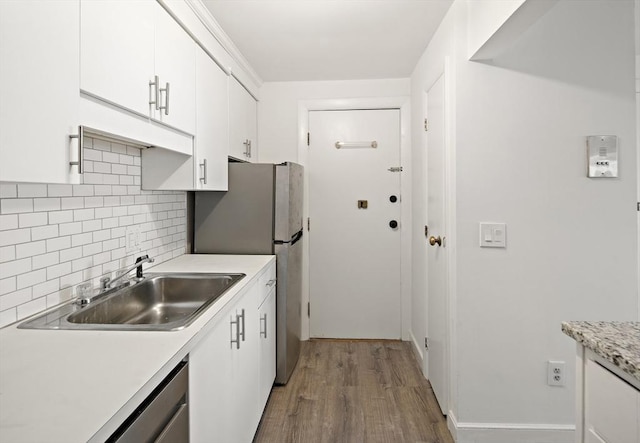 12 Commonwealth Ct Unit 12-16, Boston, MA 02135 - kitchen featuring wood finished floors, white cabinets, tasteful backsplash, light countertops, and a sink