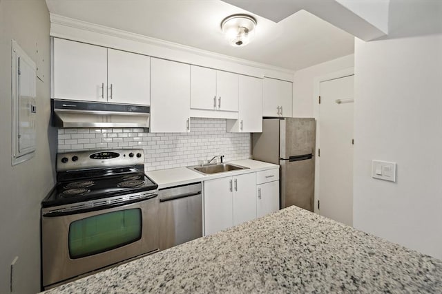12 Commonwealth Ct Unit 12-16, Boston, MA 02135 - kitchen with under cabinet range hood, stainless steel appliances, a sink, white cabinetry, and decorative backsplash