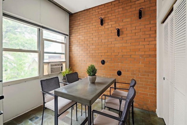 12 Commonwealth Ct Unit 12-16, Boston, MA 02135 - dining space featuring brick wall, plenty of natural light, an accent wall, and cooling unit
