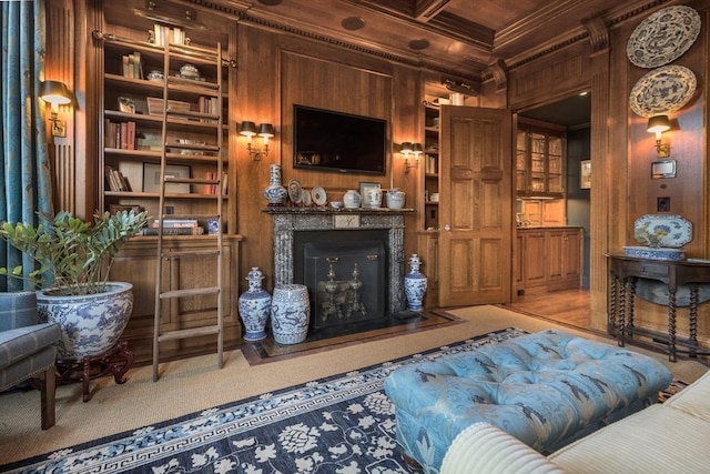 interior space featuring wooden walls, coffered ceiling, ornamental molding, built in shelves, and beamed ceiling