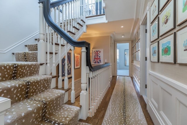 stairs with crown molding and hardwood / wood-style flooring