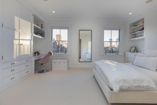 bedroom featuring multiple windows, ornamental molding, and light carpet