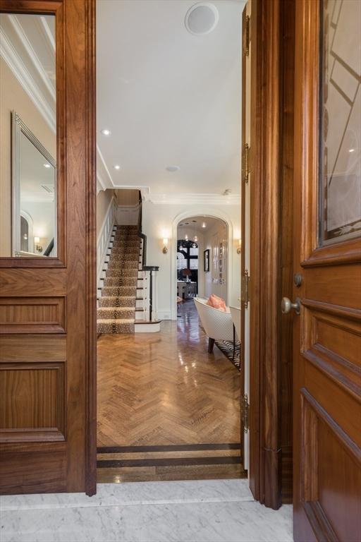 interior space featuring crown molding and light parquet flooring